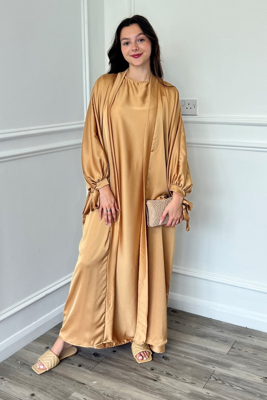 gold abaya dress Gold Abaya Golden Abaya with bishop sleeves and feather trimmings. Comes with a dress and headscarf. Abayas from Almahra Atelier at Boksha